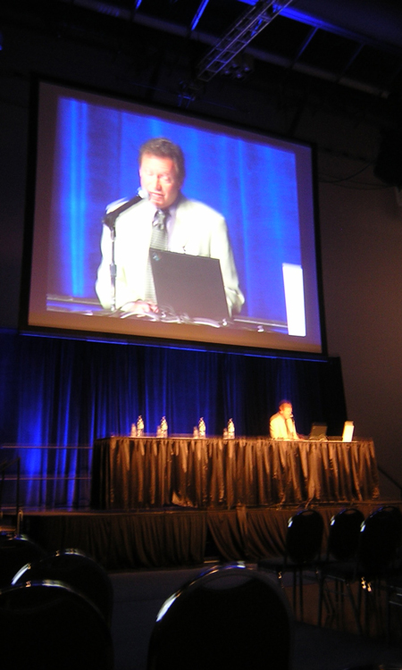 David's lecture is broadcast on a large screen.